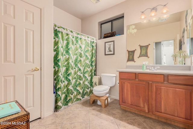 bathroom featuring vanity, toilet, and tile patterned flooring