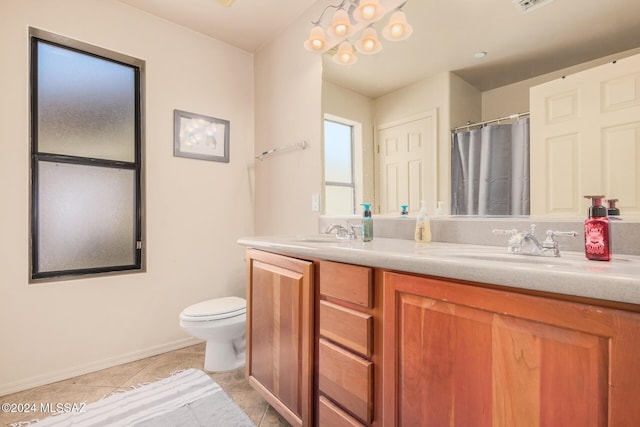 bathroom with vanity, toilet, and tile patterned flooring