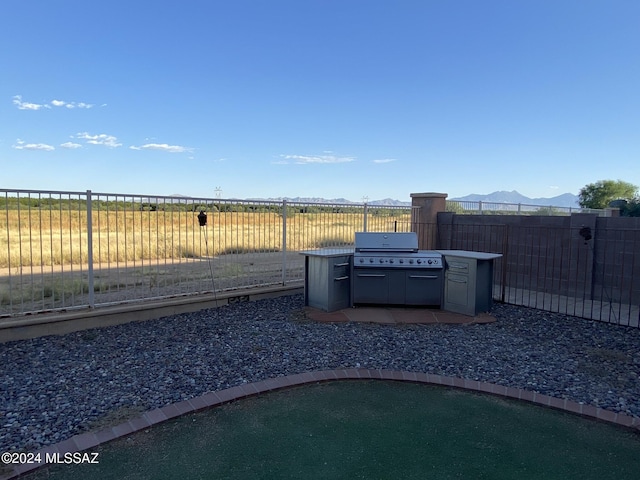 view of yard featuring an outdoor kitchen and a mountain view