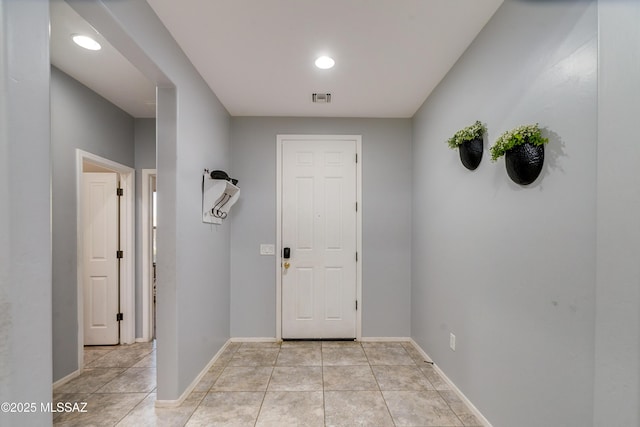 foyer with visible vents, baseboards, and light tile patterned floors