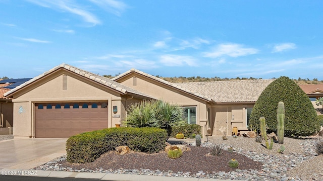 single story home featuring a tile roof, driveway, an attached garage, and stucco siding