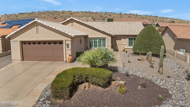 single story home featuring driveway, stucco siding, an attached garage, and a tiled roof