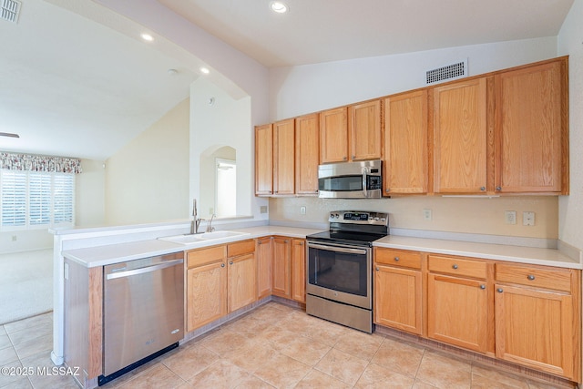 kitchen with lofted ceiling, light countertops, visible vents, appliances with stainless steel finishes, and a sink