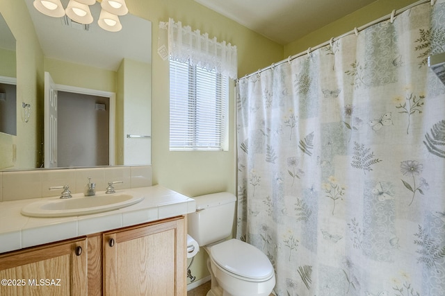 full bathroom featuring toilet, visible vents, and vanity