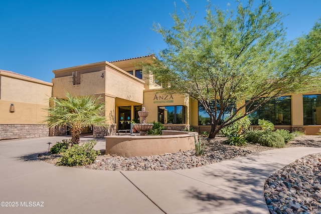 view of front of home featuring driveway and stucco siding