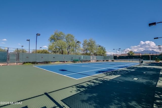 view of tennis court with fence