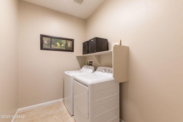 laundry area featuring light tile patterned floors, laundry area, separate washer and dryer, visible vents, and baseboards