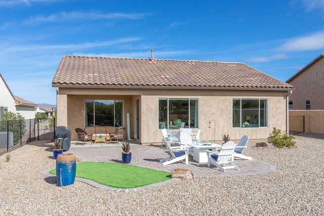 back of property featuring a tile roof, a patio, a fenced backyard, and stucco siding