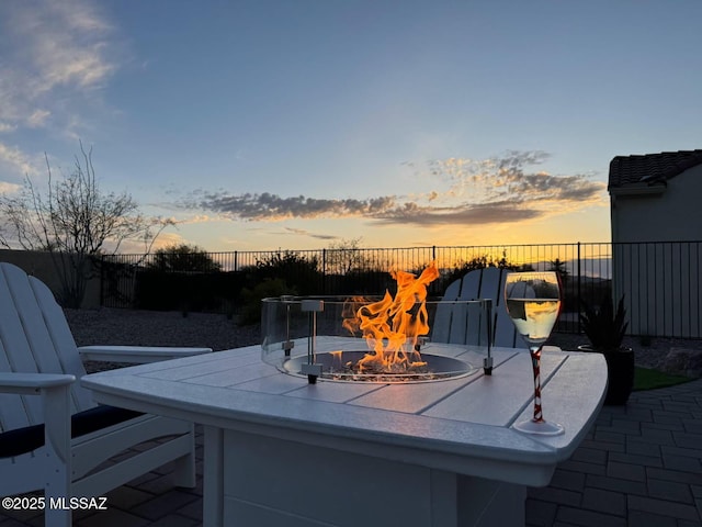 exterior space with an outdoor fire pit and fence