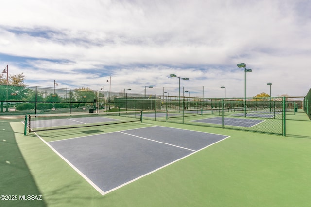 view of tennis court featuring fence