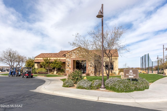 view of front of home featuring a tiled roof and stucco siding