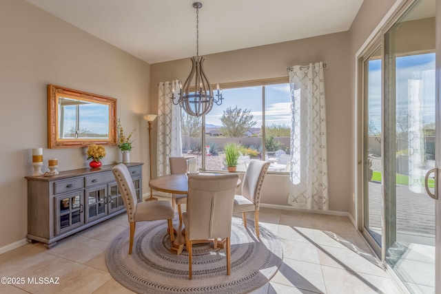 dining room featuring a chandelier, baseboards, and light tile patterned floors