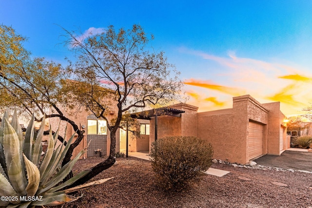 view of property exterior featuring an attached garage and stucco siding