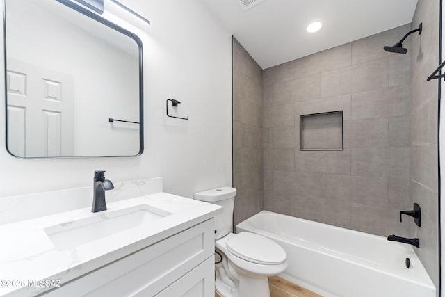 full bathroom with bathing tub / shower combination, recessed lighting, toilet, vanity, and wood finished floors