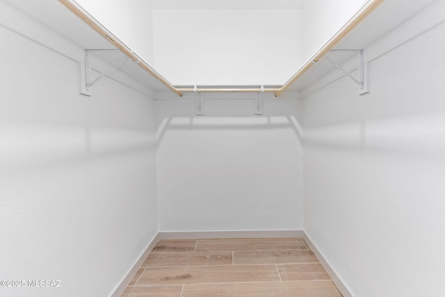 spacious closet featuring wood tiled floor