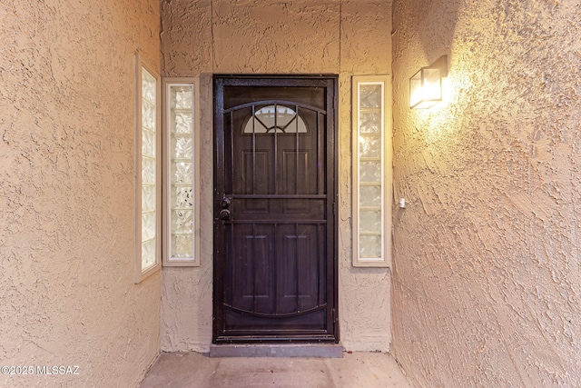 doorway to property with stucco siding