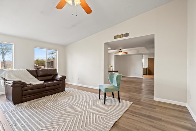 living room featuring ceiling fan, vaulted ceiling, and hardwood / wood-style floors