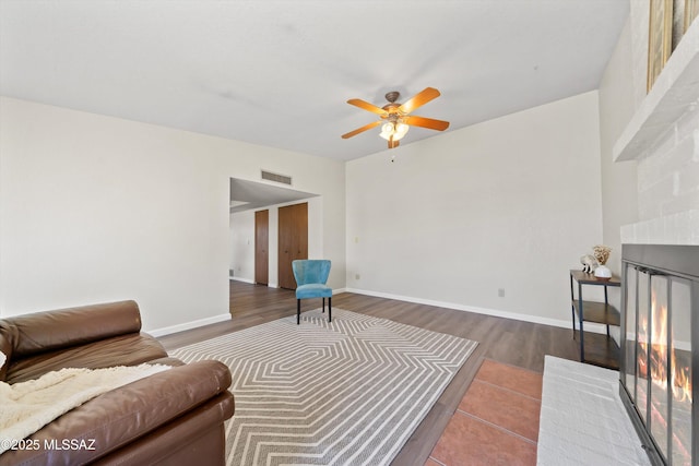 living room with hardwood / wood-style flooring and ceiling fan