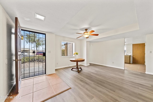 foyer entrance featuring ceiling fan, light hardwood / wood-style floors, and a textured ceiling