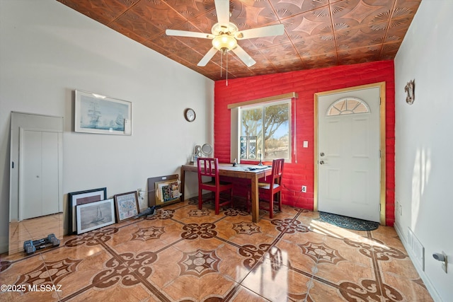 dining space featuring an ornate ceiling, a ceiling fan, and tile patterned flooring