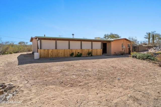 back of property with stucco siding