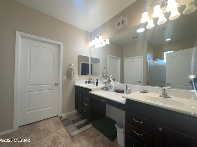 bathroom featuring vanity and a shower with door