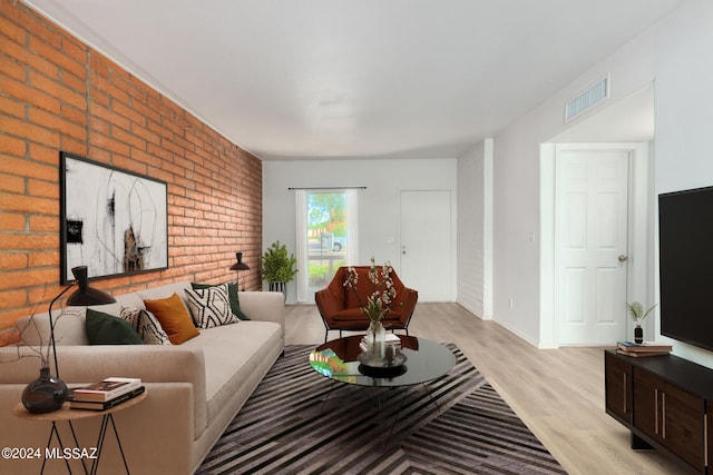 living room with brick wall and light wood-type flooring