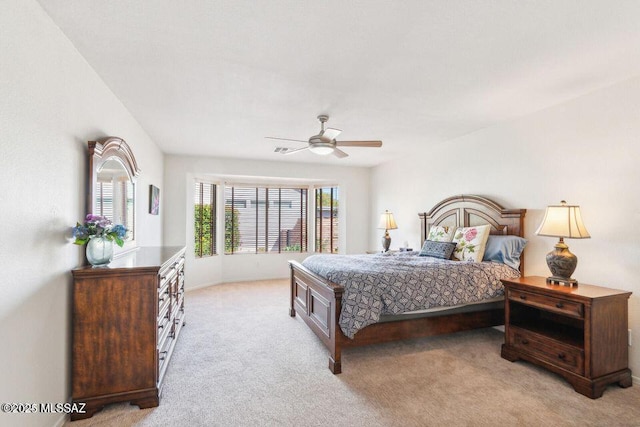 bedroom featuring light carpet and a ceiling fan