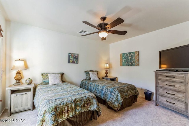 bedroom with light colored carpet, visible vents, and ceiling fan