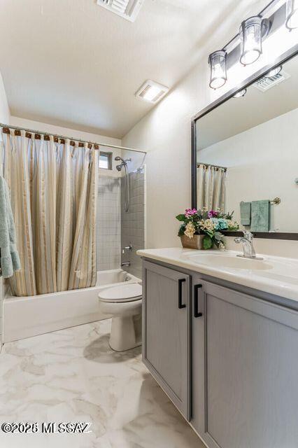 full bath with visible vents, toilet, shower / tub combo with curtain, marble finish floor, and vanity