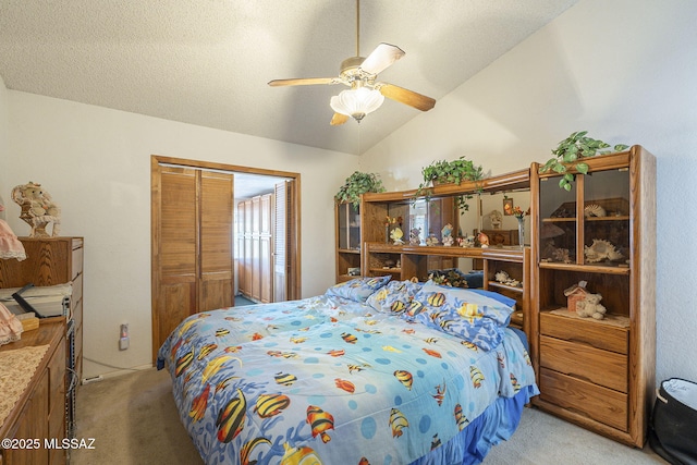 bedroom featuring ceiling fan, a textured ceiling, vaulted ceiling, light colored carpet, and a closet