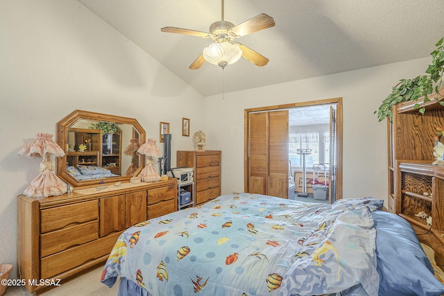 bedroom featuring vaulted ceiling, a textured ceiling, carpet flooring, a closet, and ceiling fan