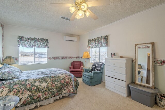 carpeted bedroom featuring crown molding, ceiling fan, a textured ceiling, and a wall mounted AC
