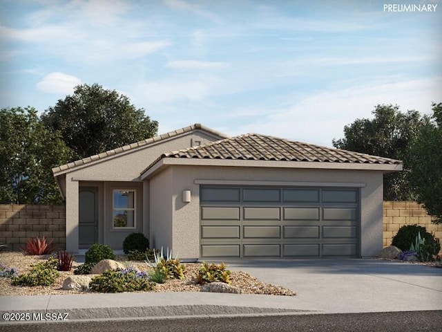 view of front of house featuring a garage, a tiled roof, concrete driveway, and stucco siding