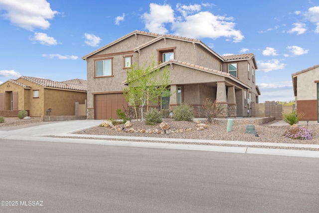 view of front of property with driveway, an attached garage, a tile roof, and stucco siding