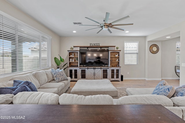 living area featuring recessed lighting, visible vents, light wood-style floors, ceiling fan, and baseboards