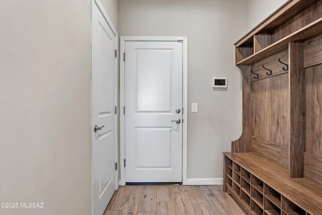 mudroom featuring light wood-style floors and baseboards