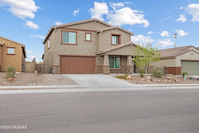 view of front facade with driveway, stone siding, fence, and stucco siding