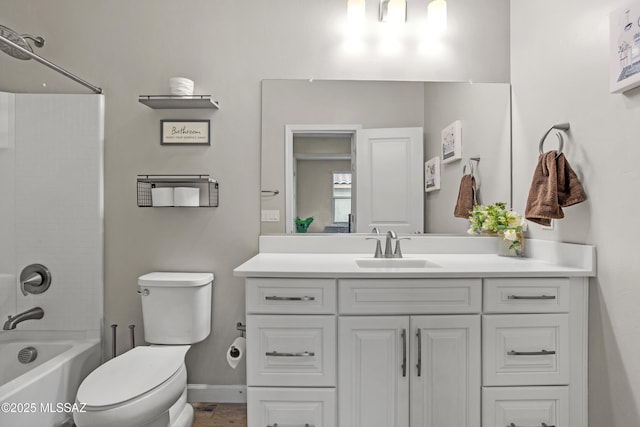 bathroom featuring baseboards, shower / tub combination, vanity, and toilet