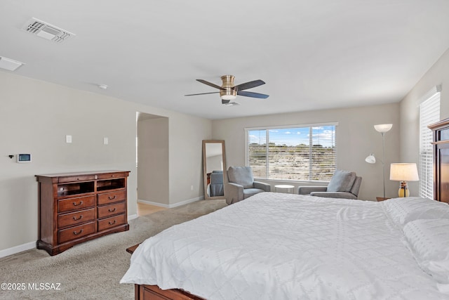 bedroom featuring visible vents, baseboards, ceiling fan, and light colored carpet