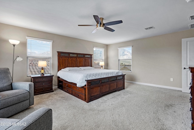 bedroom with light carpet, a ceiling fan, visible vents, and baseboards