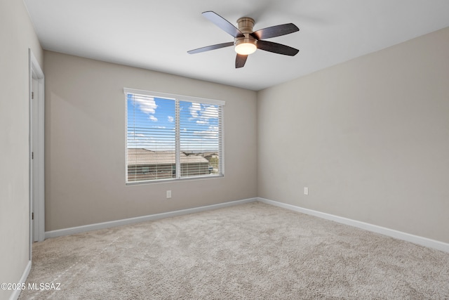 unfurnished room featuring a ceiling fan, carpet flooring, and baseboards