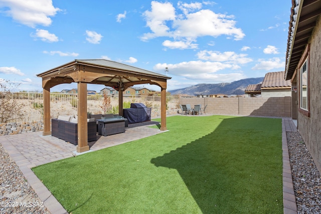 view of yard featuring a patio, a fenced backyard, a mountain view, an outdoor living space, and a gazebo