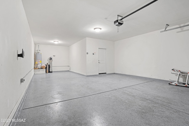 garage featuring baseboards, gas water heater, and a garage door opener