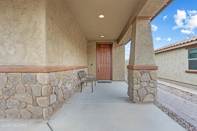 entrance to property with stucco siding