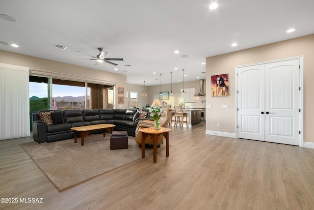 living area featuring light wood-type flooring, visible vents, ceiling fan, and recessed lighting