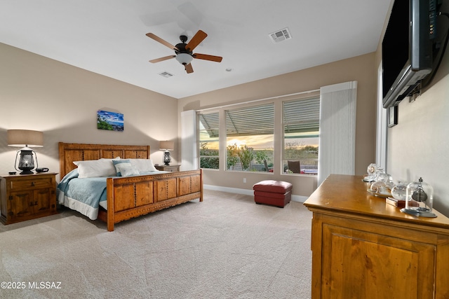 bedroom with light colored carpet, visible vents, ceiling fan, and baseboards