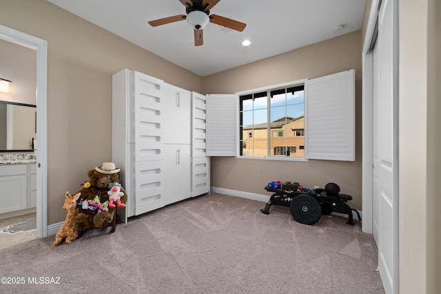 interior space with a ceiling fan, recessed lighting, light colored carpet, and baseboards