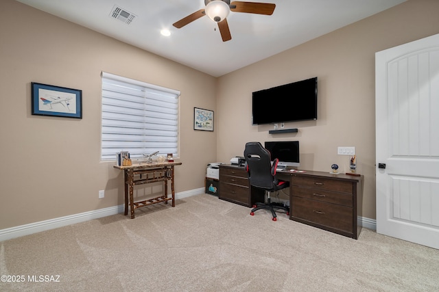 office area featuring baseboards, visible vents, a ceiling fan, and light colored carpet