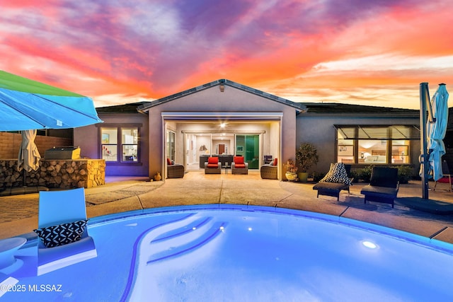 pool with a patio area and area for grilling